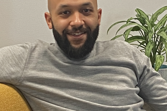 photo of bald man with beard in a gray shirt