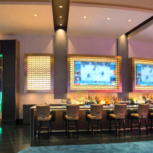 Modern casino bar with LIT Smoking Gaming entrance, illuminated screens, upscale seating, and sleek nightclub-style interior inside luxury resort